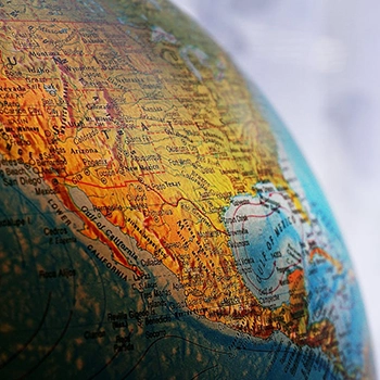 An engineer looking at aerial photos to plan a project.