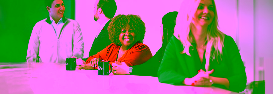 Smiling NFA employees sitting at a table.