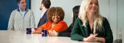 Smiling NFA employees sitting at a table.