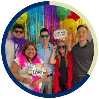 A group of smiling NFA employees posing for a photo at an LGBTQ+ Pride event.