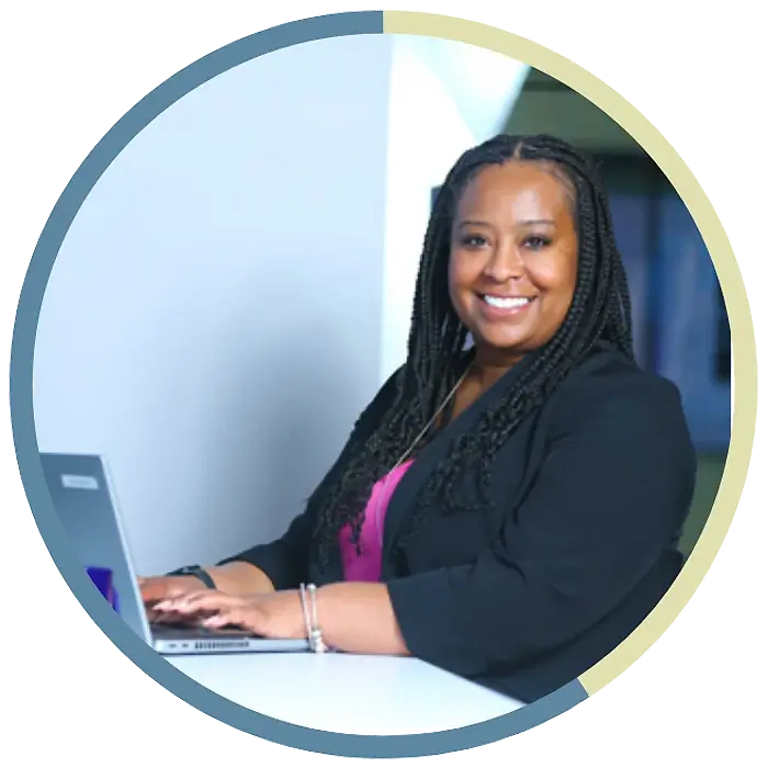 A happy NFA employee typing on a laptop.