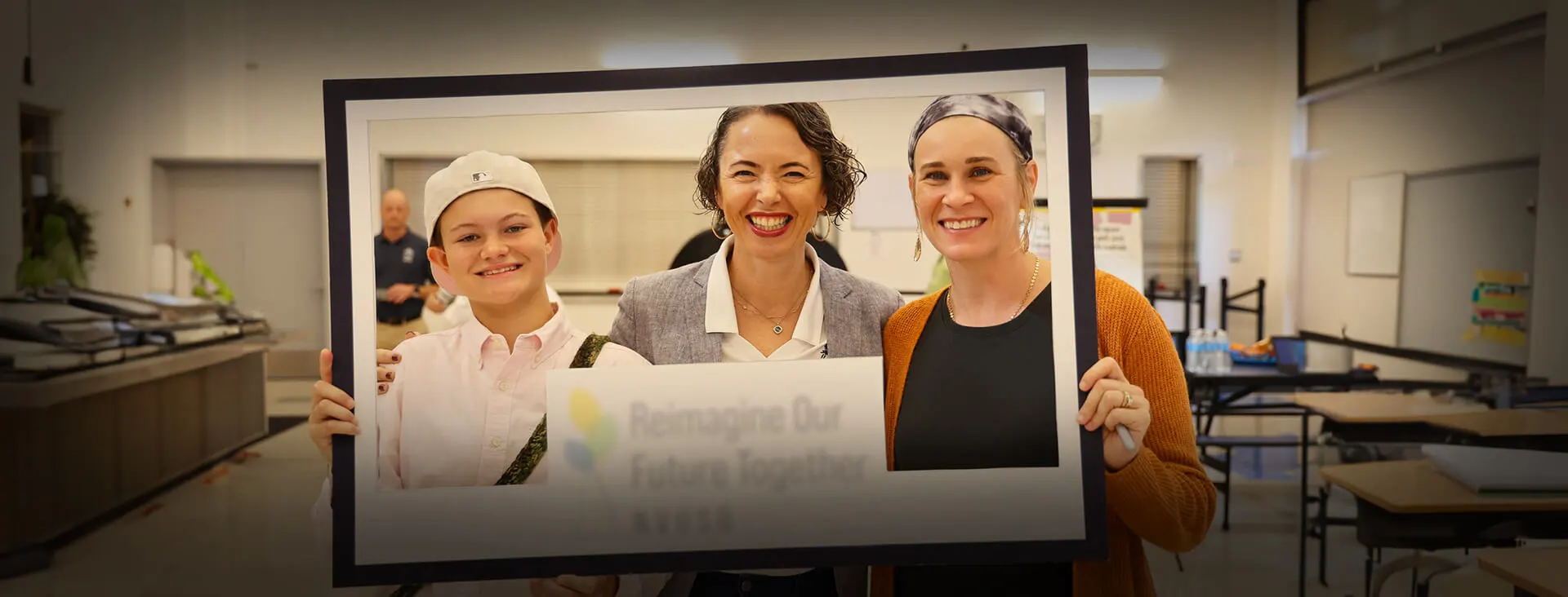 Student, teacher and parent smiling through the feame