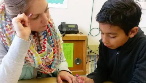 Teacher sitting with child