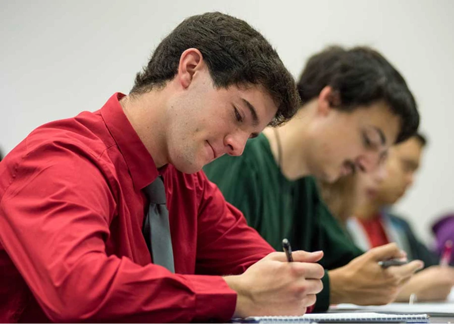 Students writing in notebooks.