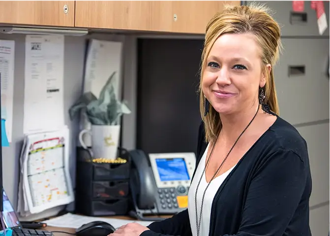 Pharmacy Technician Colleen Smith sitting at her desk.
