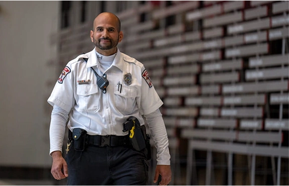 A member of the security team walking down a hallway.