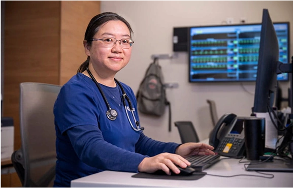 An OSU Medical Center nurse sitting at a desk.