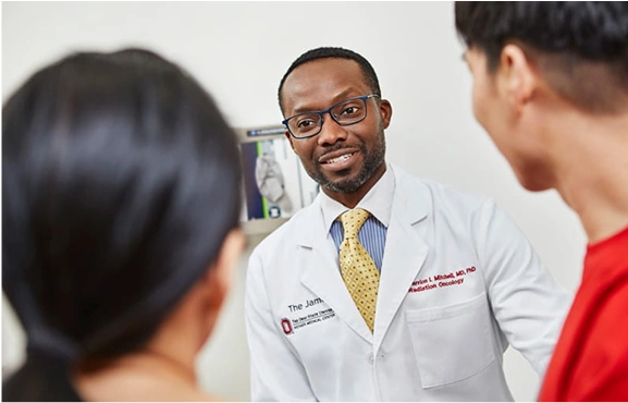 A faculty physician talking to students.