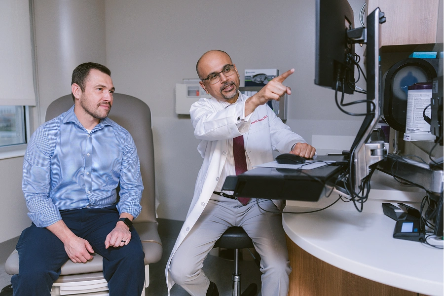 A doctor and patient talking in a medical office.