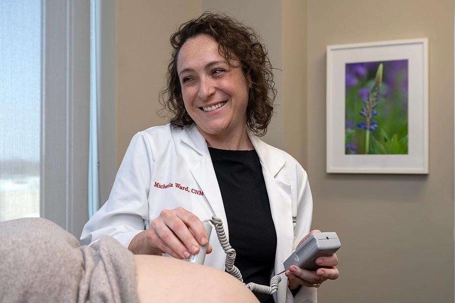 A medical professional performing a pregnancy ultrasound.