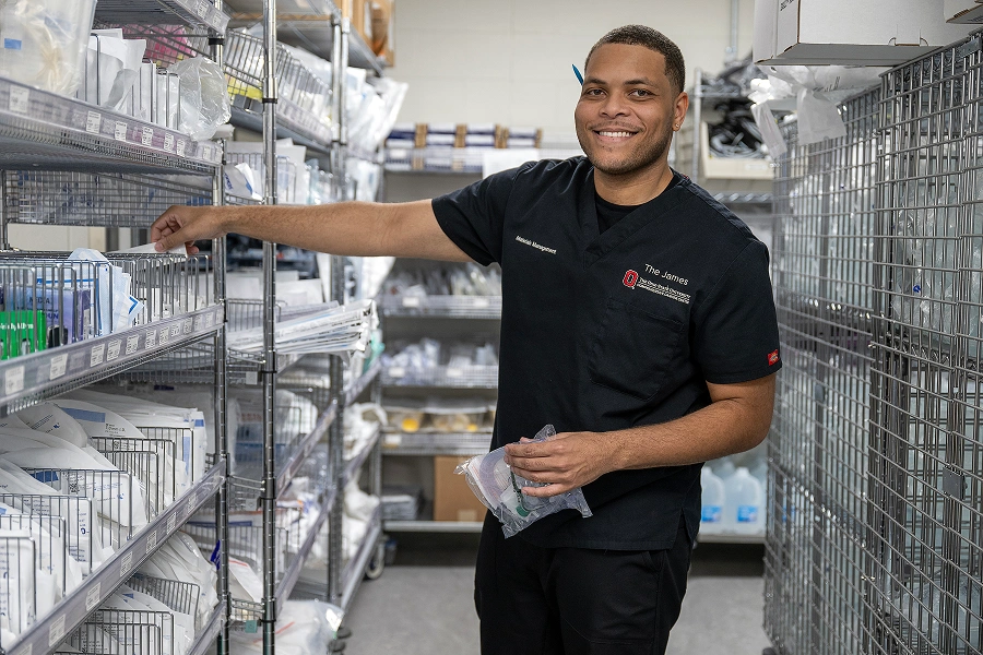 A happy employee sorting medical supplies.