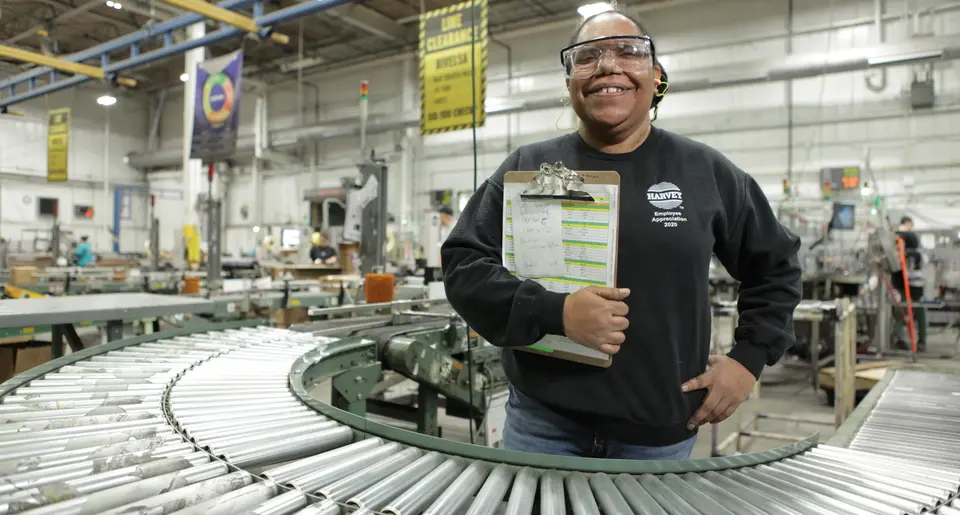 A smiling Oatey employee working at their station.