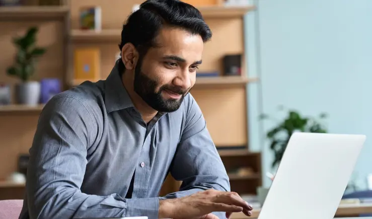 One Medical employee working on a laptop.