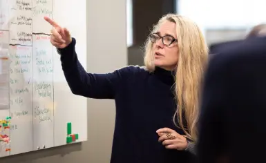 One Medical employee reviewing data on a whiteboard.