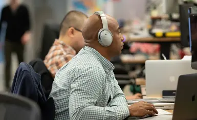 One Medical employee working on a computer.