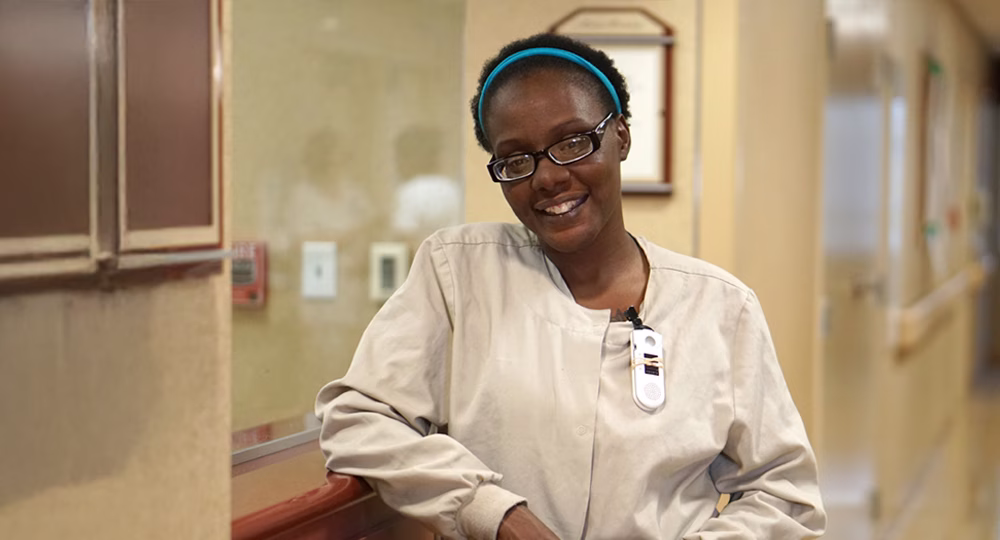 Healthcare team member smiling in a hallway