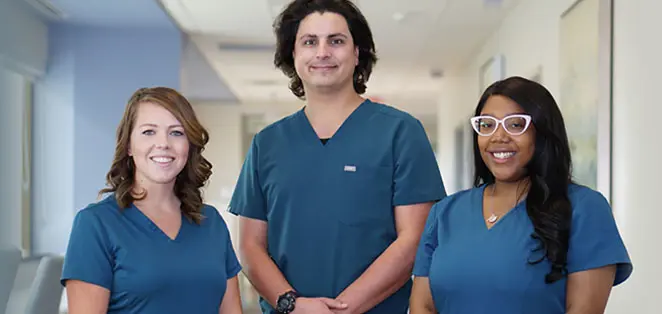 Three diverse nurses in teal scrubs at Phoebe Health