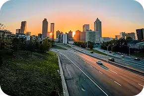 Sun setting between the buildings of downtown Atlanta.