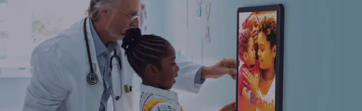  	Medical provider educating a young patient using PatientPoint technology.