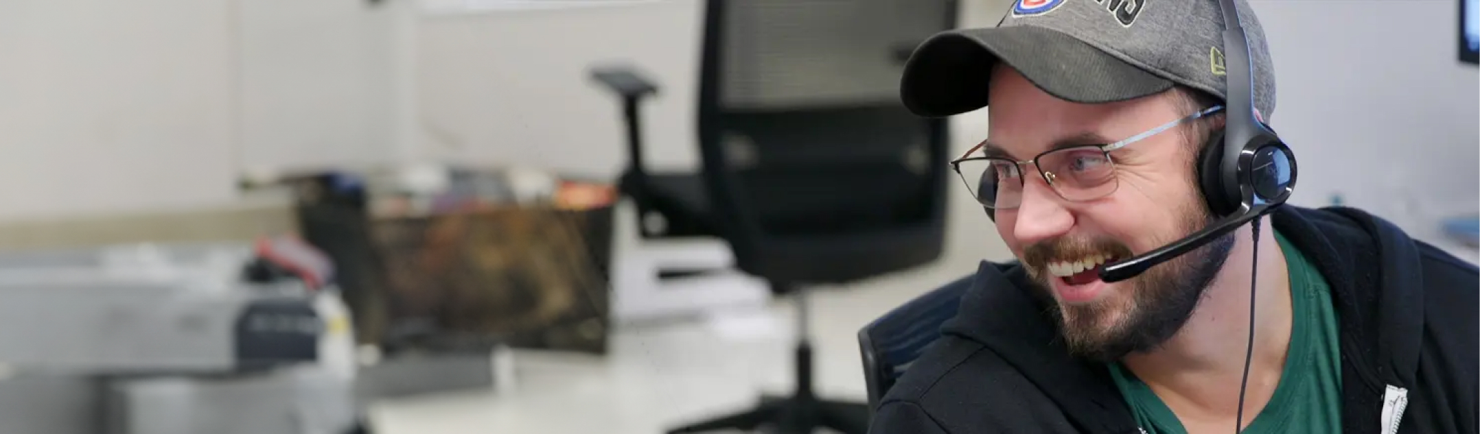 PatientPoint employee wearing a headset and smiling.