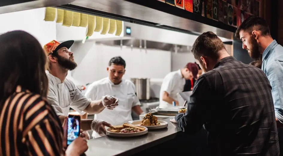 Postino employees working in a kitchen.