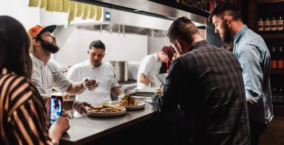 Postino employee pouring a drink.