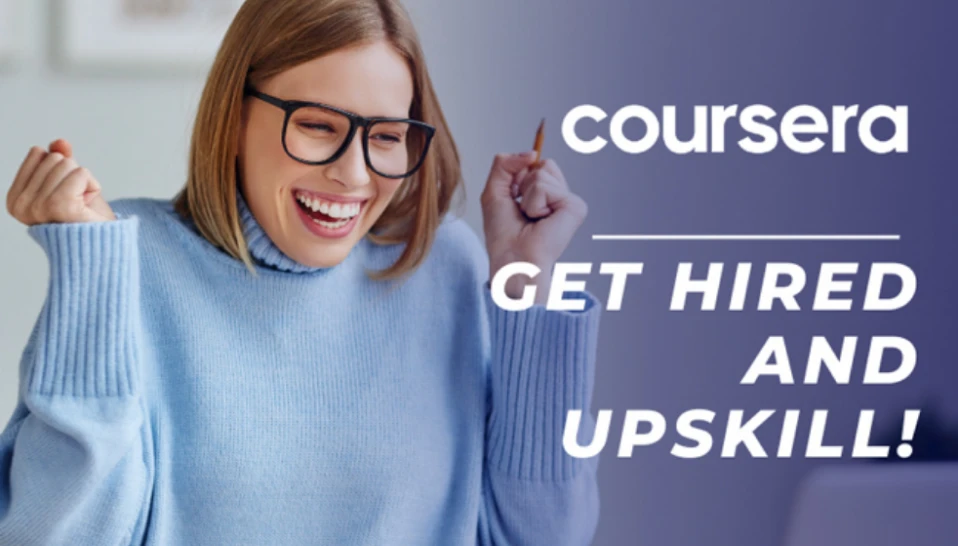 A woman smiling with excitement as she uses Coursera to Get Hired and Upskill.