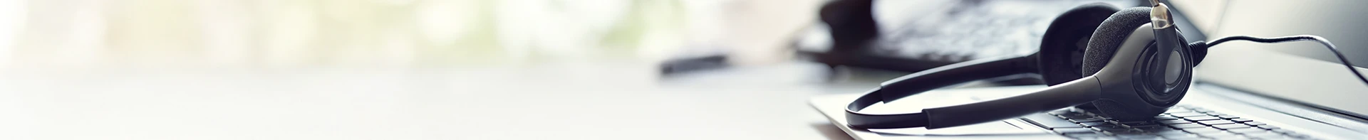 Customer service headphones sitting on a desk.