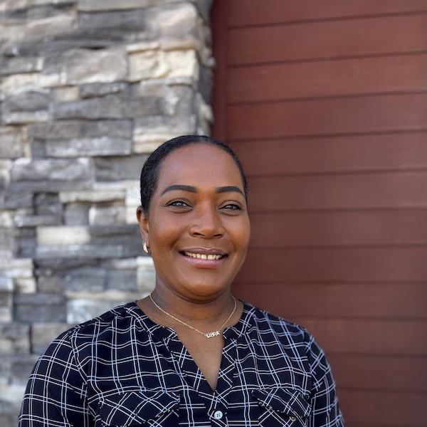 A Red Lobster Certified Restaurant Supervisor standing outside and smiling.