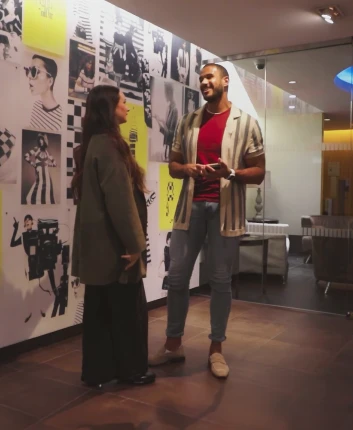 Two Ross Buying and Planning Associates having a conversation in a hallway