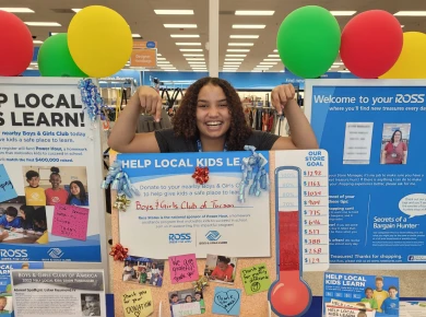 Ross Associate with posters highlighting various community efforts