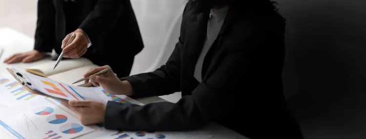 Ross corporate Associates reviewing spreadsheets