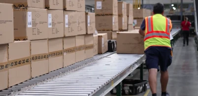 Associate in safety vest at a Ross distribution center warehouse