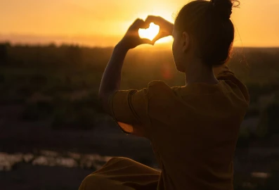 Girl holding hands in shape of heart