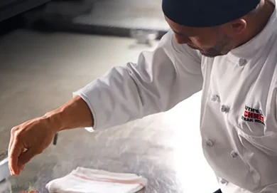 Ruth's Chris Steakhouse chef seasoning the dish