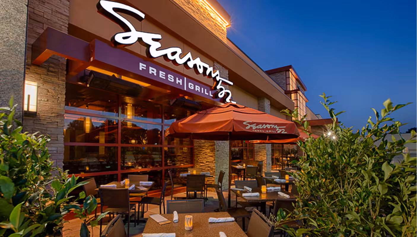 A Seasons 52 restaurant exterior behind an outdoor patio.