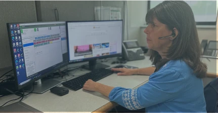 A South Shore Health System administrative professional working on a computer.