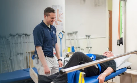A physical therapist working with a patient.