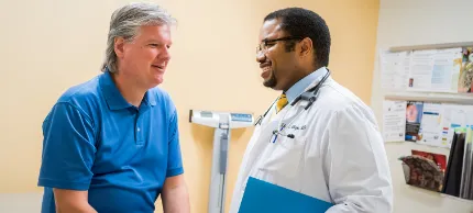 South Shore Health physician consults with a patient in an examining room