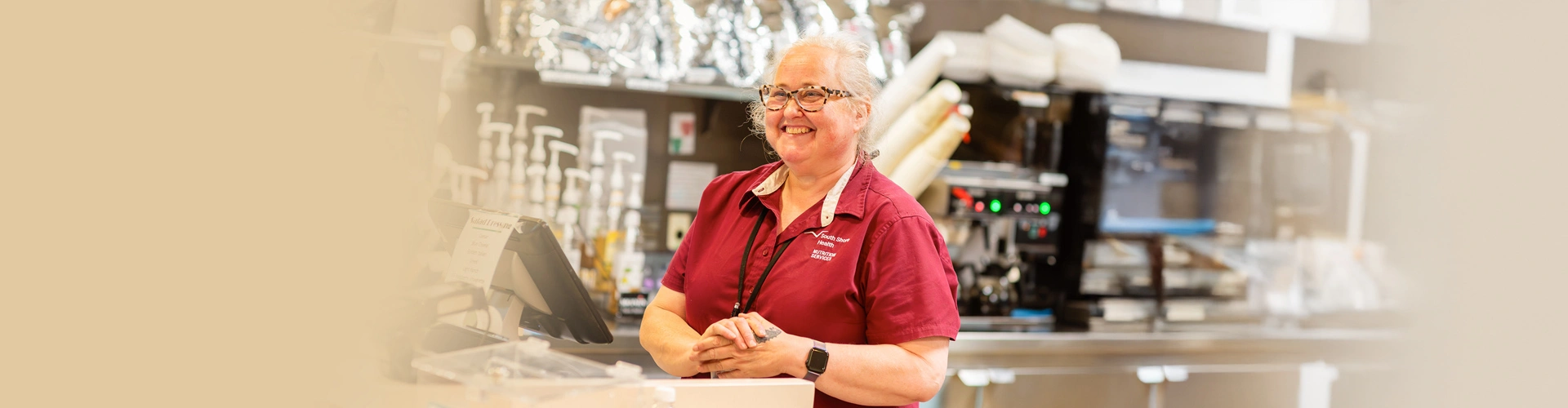 A South Shore Health food services team member smiling while working at an on-site café