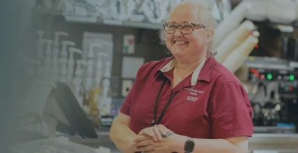 A South Shore Health food services team member smiling while working at an on-site café.