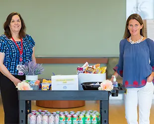 South Shore Health employees standing with a fully stocked refreshments table