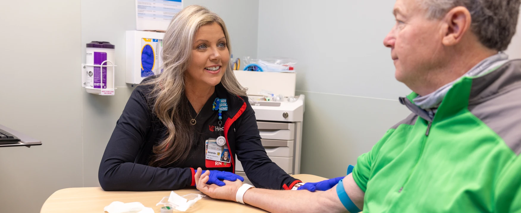 A UC Health team member preparing a patient for a blood draw.