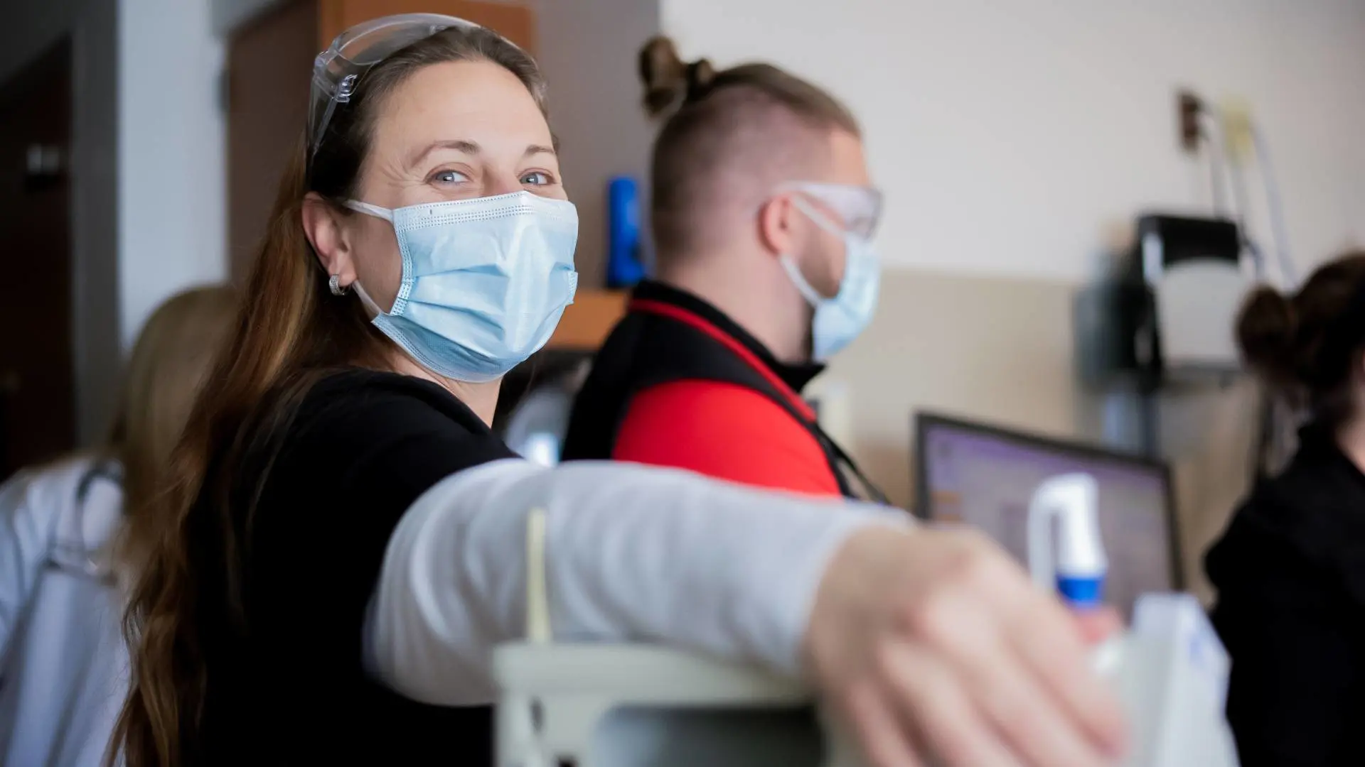 Smiling and welcoming nurse with facemask