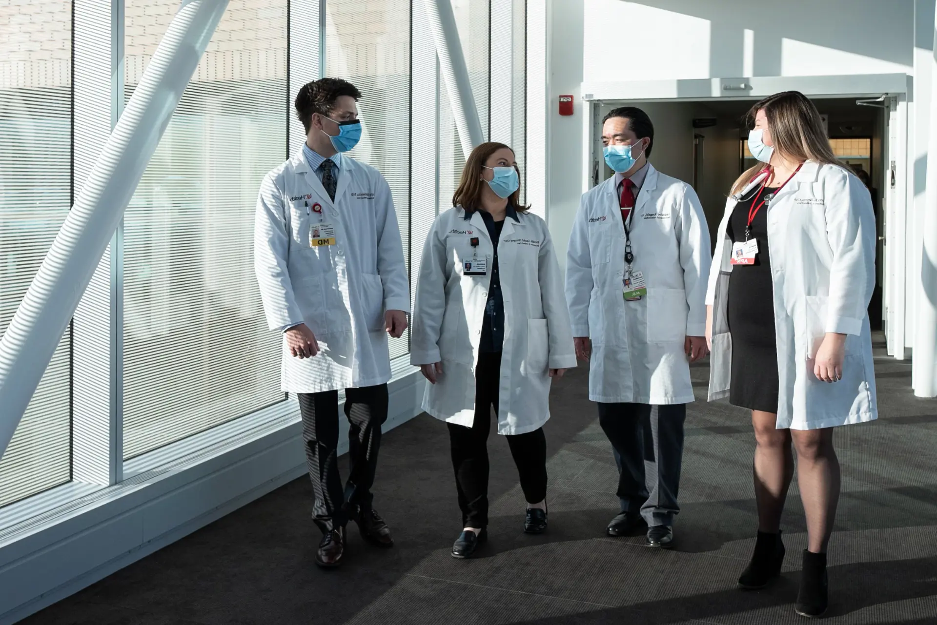  Group of physicians walking on uc health facility 