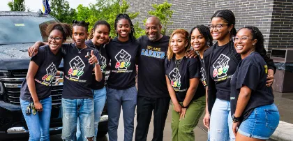 A group of educators standing together and smiling.