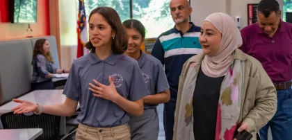 A Wake County student and a teacher walking together.