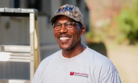 A Wake County technician smiling.