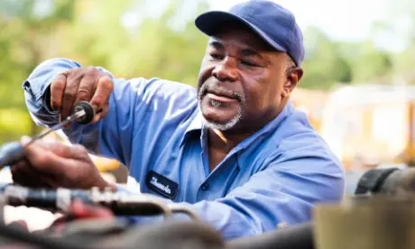 A bus mechanic working on the job.