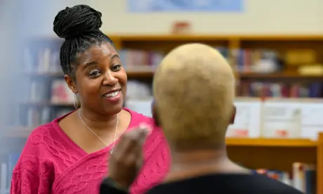 A Wake County leader interacting with a staff member and smiling.